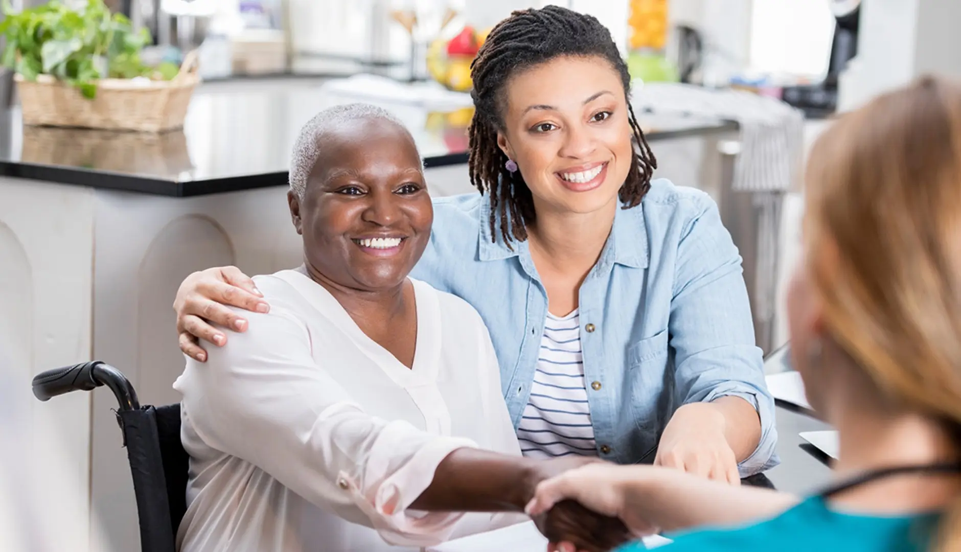 A caregiver greeting a client and her family at home
